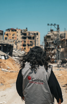 A Caritas Worker Walks Through The Destruction In Gaza Photo Credit Caritas Jerusalem