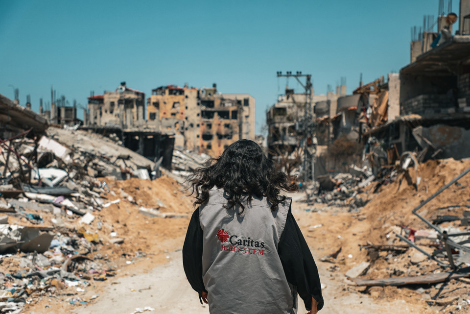 A Caritas Worker Walks Through The Destruction In Gaza Photo Credit Caritas Jerusalem