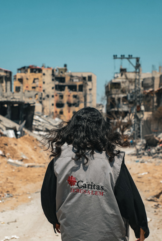 A Caritas Worker Walks Through The Destruction In Gaza Photo Credit Caritas Jerusalem