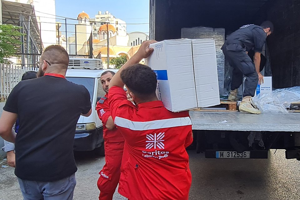 Caritas Lebanon Employees Load Supplies Into A Van Photo Credit Caritas Lebanon