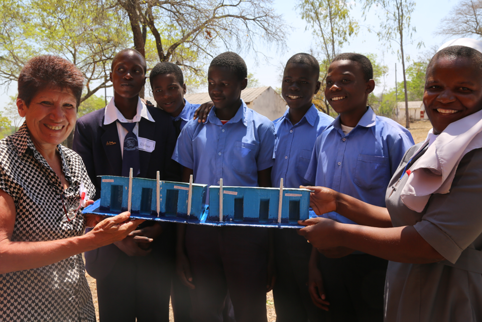 Employee helping group of school students