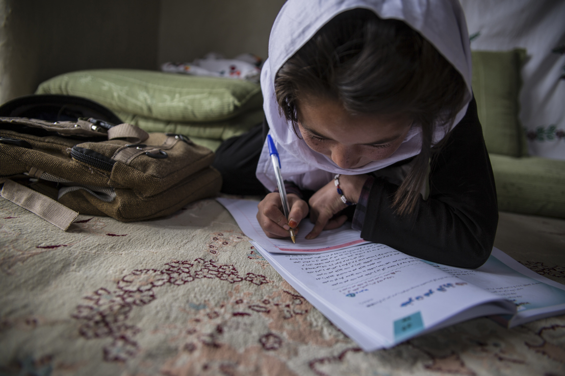 A Young Girl In Afghanistan Studies In A Remote Village Supported By CRS For Educational Programs. Photo Stefanie Glinski For CRS.