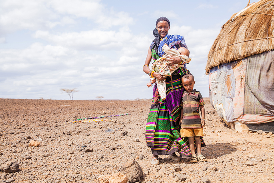 Talaso and her children outside their home in Kenya