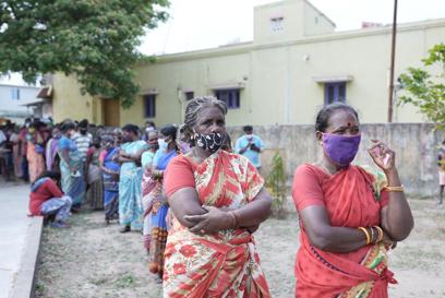 Women Queue at COVID-19 Information Centre In India