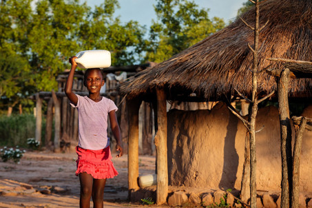 Thandolwayo Outside Her Home Holding Water In Zimbabwe, Caritas Australia