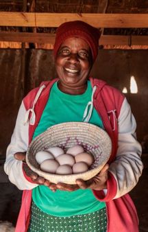 Priscilla Holding Basket Of Eggs