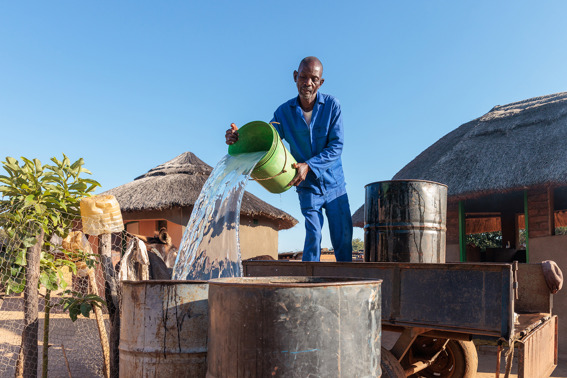 Charles Pouring Water into a drum