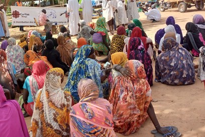 Women And Children Wait To Recieve Aid At A Transit Camp For Sudanese Refugees Photo Credit Caritas Mongo
