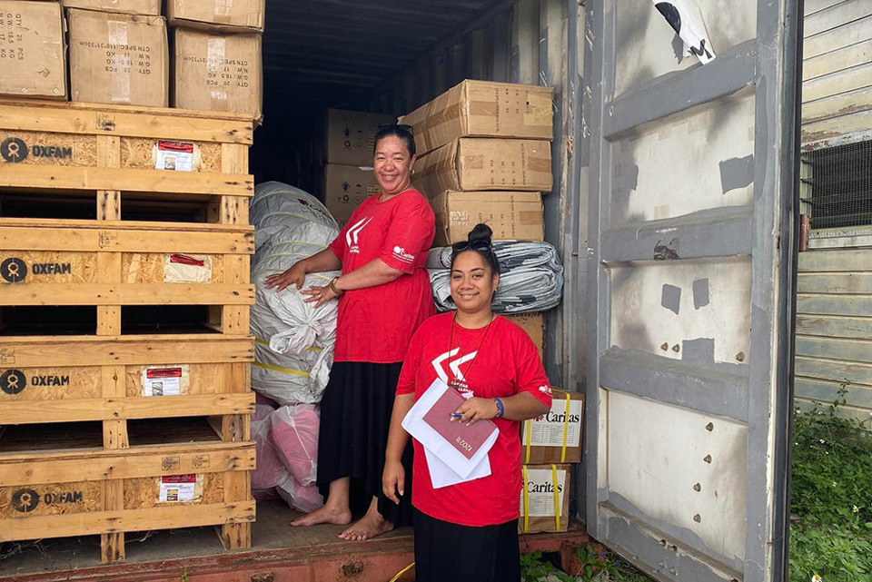 Caritas Tonga staff unloading supplies