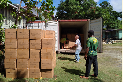 Men unpacking truck with PPE in PNG