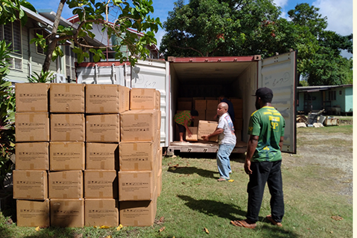 Men unpacking truck with PPE in PNG