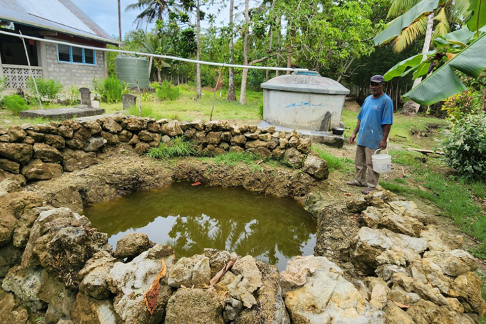 Peter Wale Collecting Water From A Well In Surabuta