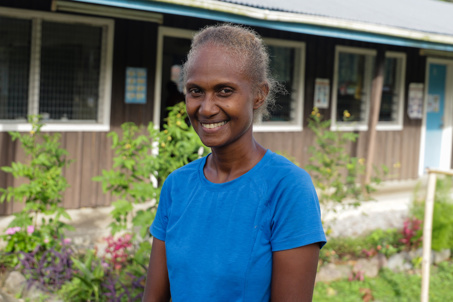 Margret standing outside a school in the Solomon Islands