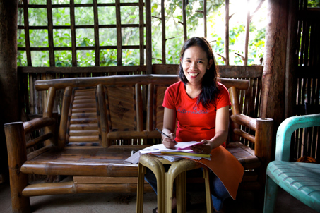 Woman working on accounts at home in the Philippines