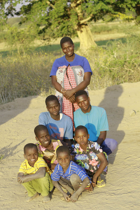 Maria with her children outside their home in Tanzania